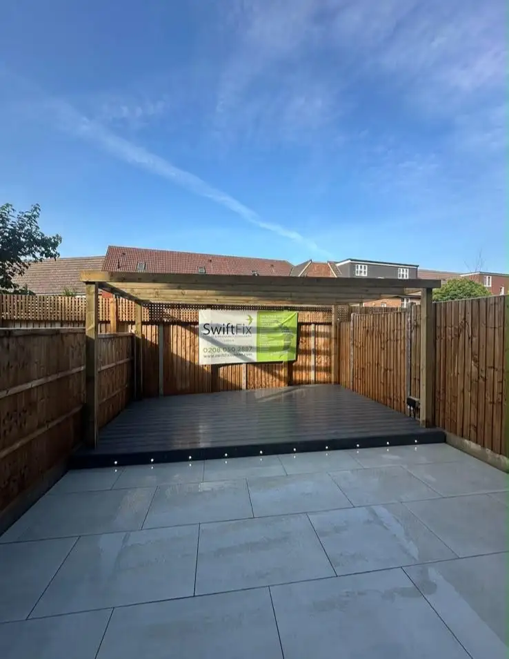 Completed garden with grey porcelain patio, raised composite deck with lights and timber pergola