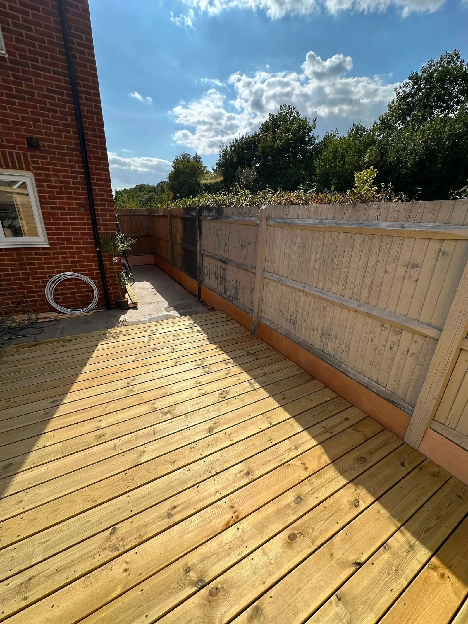 Long timber deck along a garden boundary