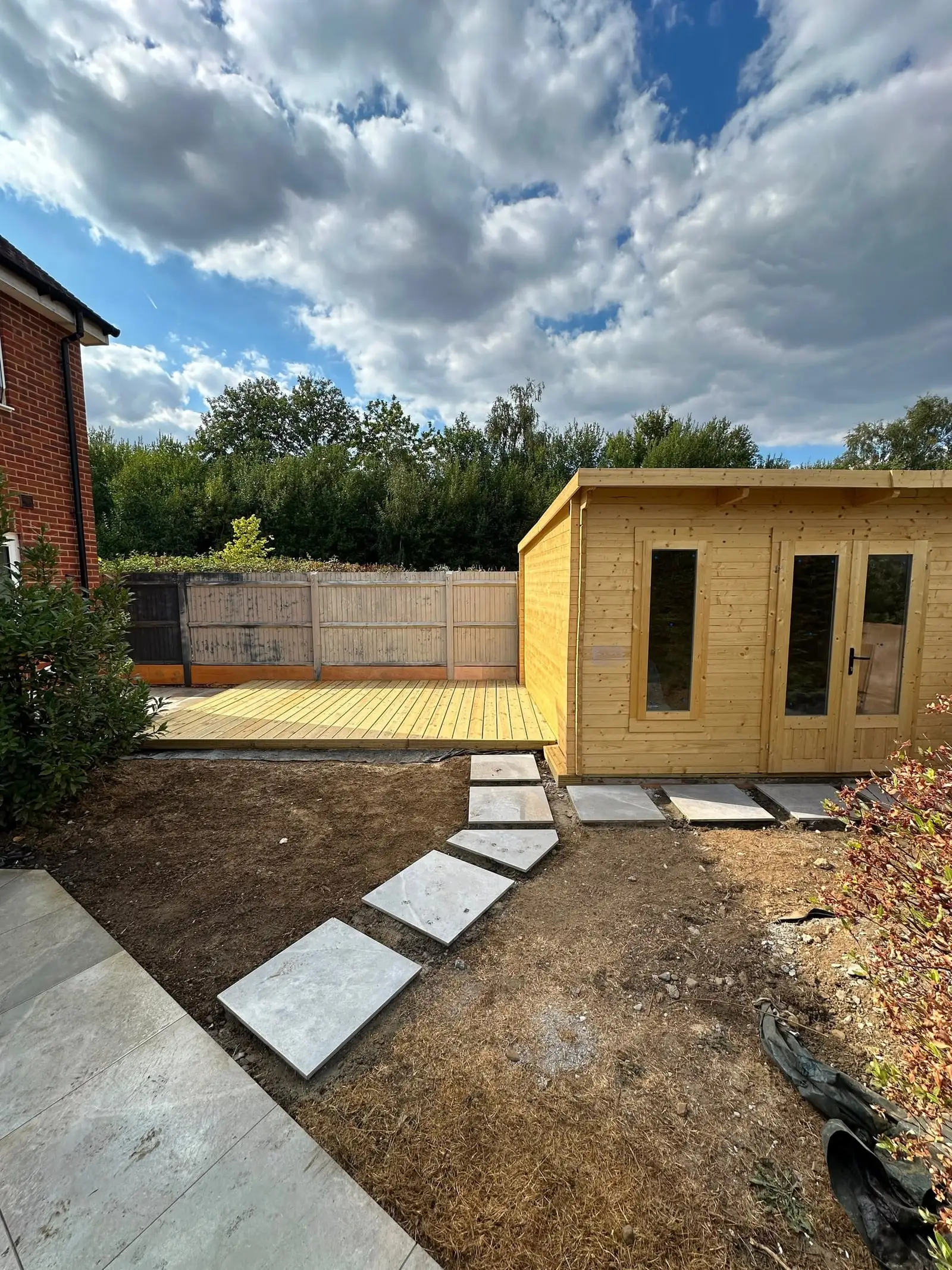 Stepping-stone path across the lawn to a garden room