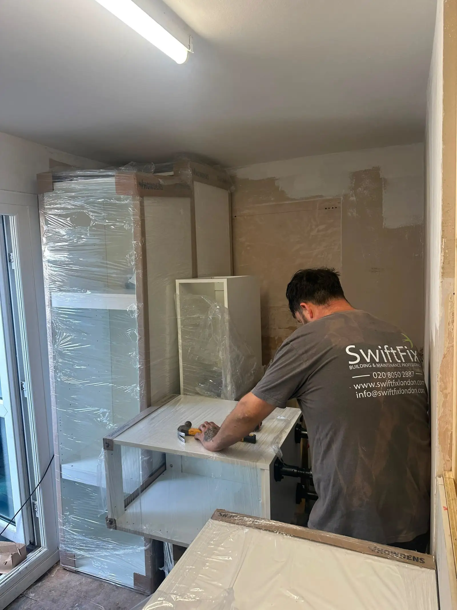 Swift Fix fitter installing kitchen units