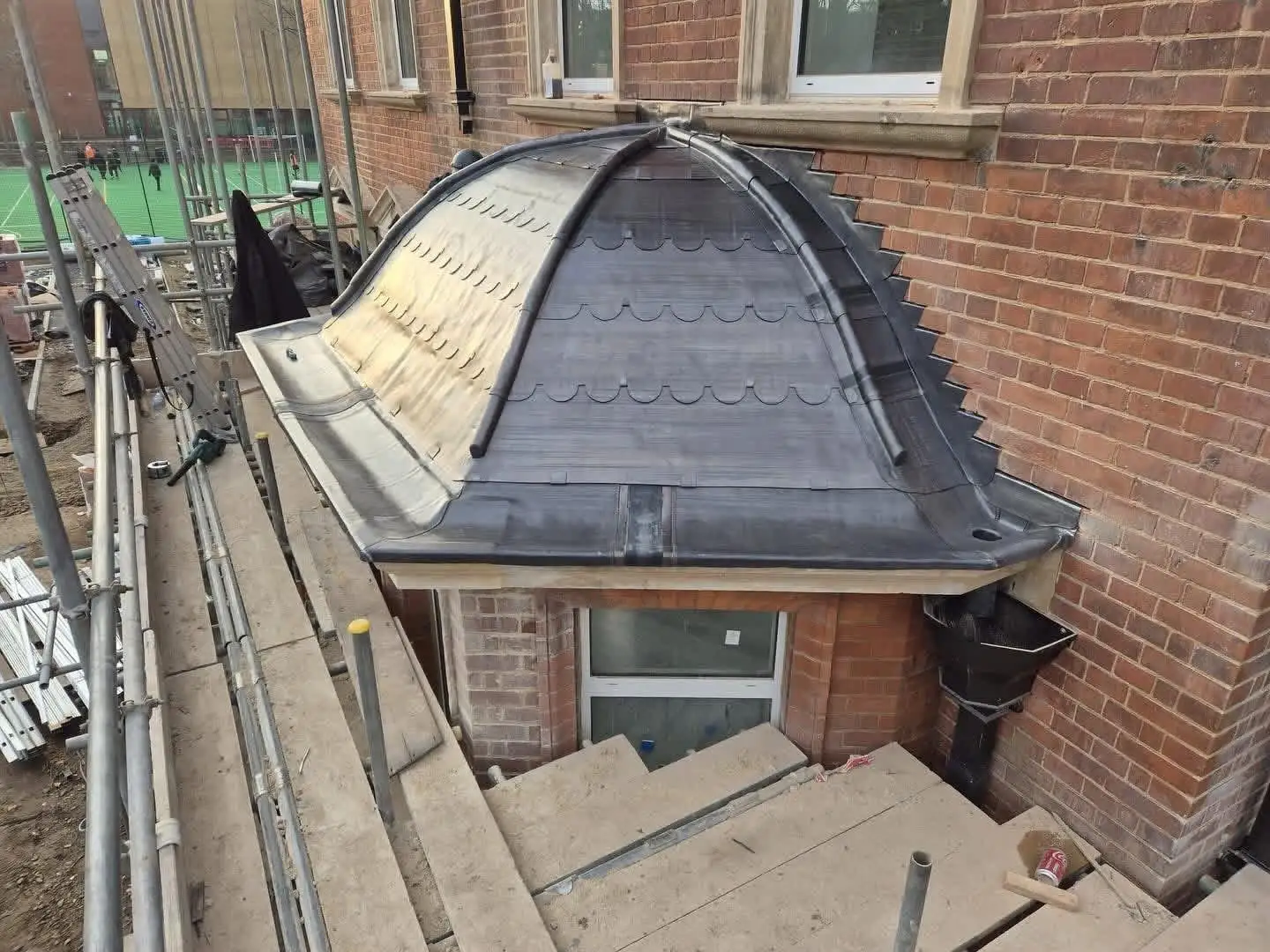 Domed bay roof newly clad in lead with hand-dressed rolls, seen from the scaffold