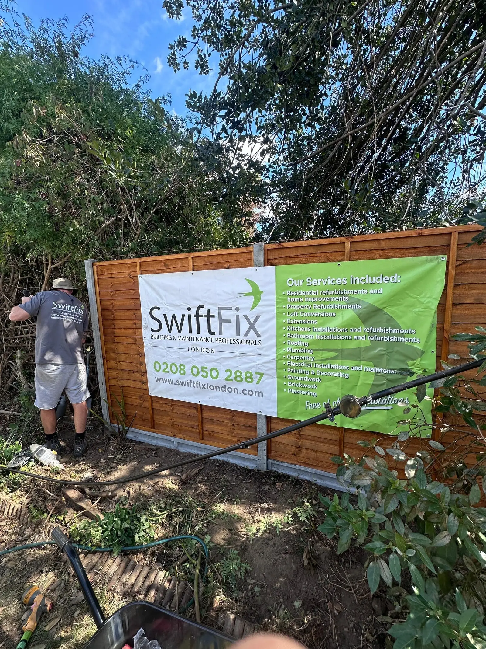 Overgrown garden being cleared, with a Swift Fix banner on the fence
