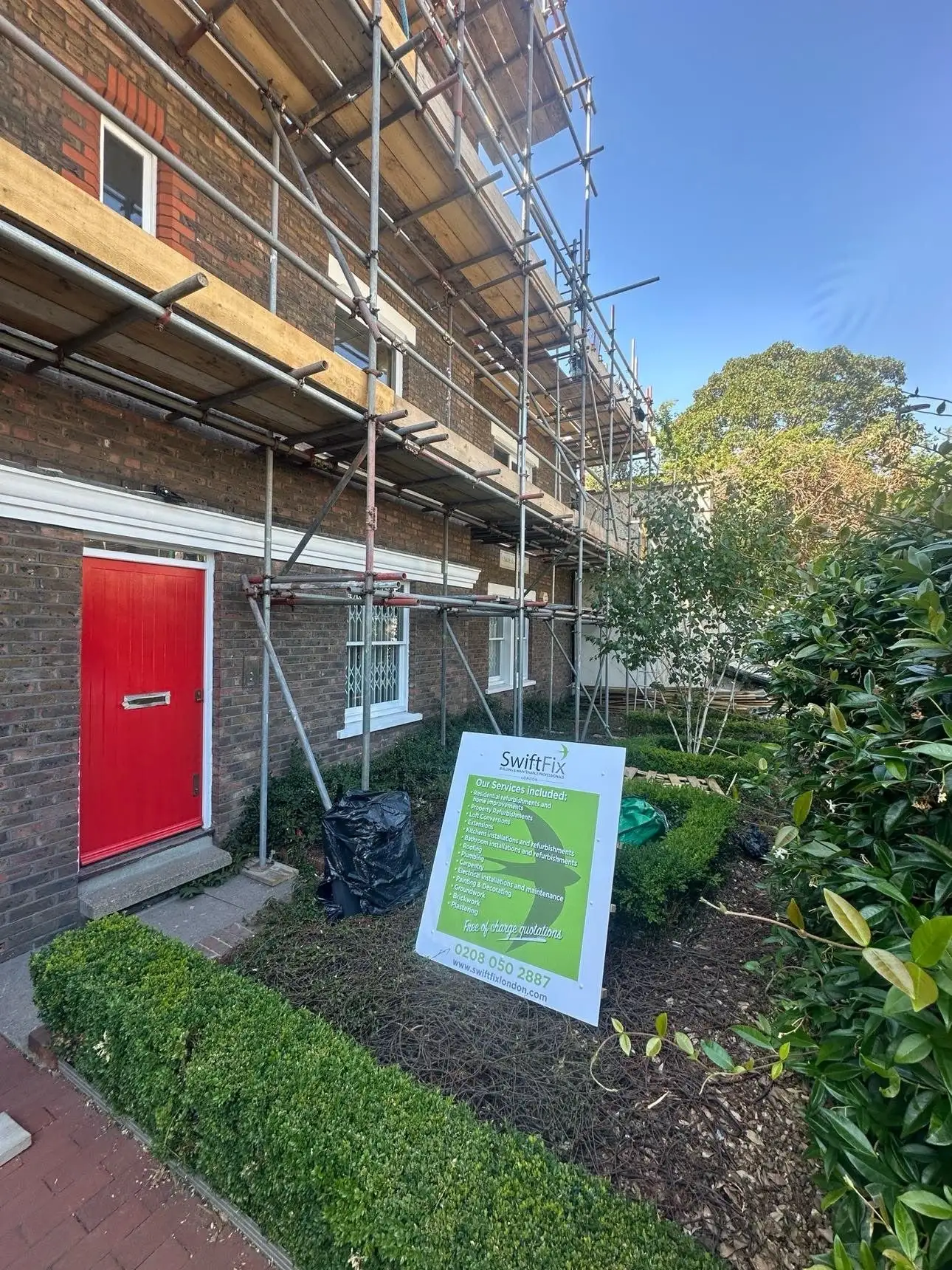 House under scaffolding during maintenance and repair works