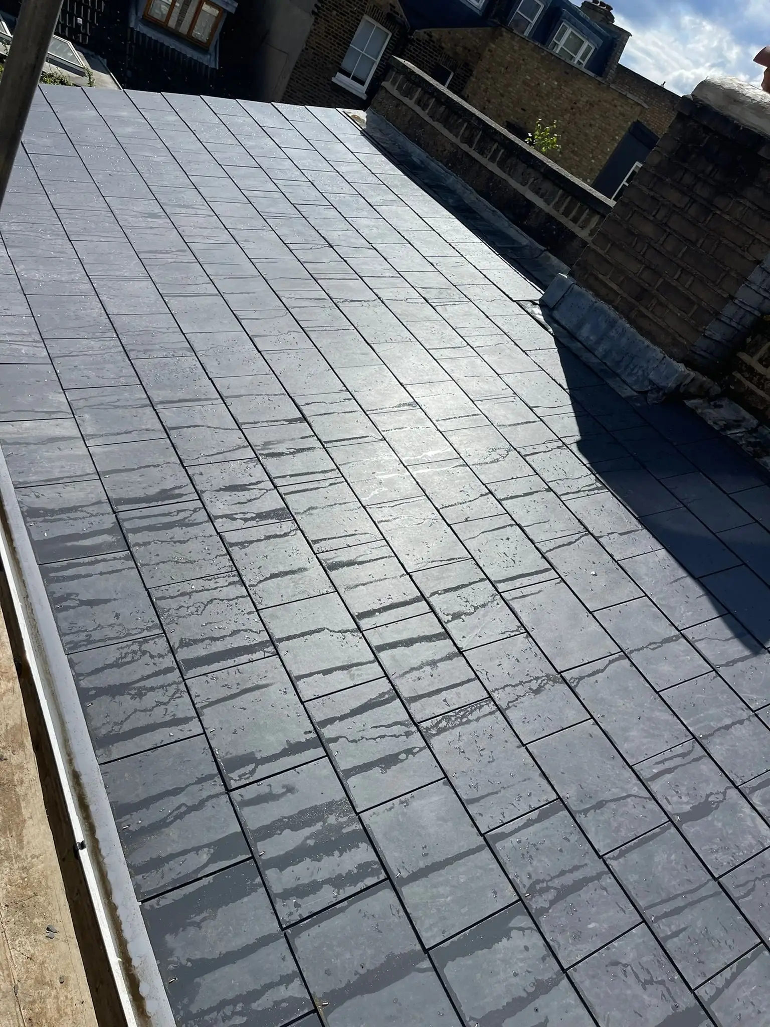 Newly laid slate roof slope with straight courses