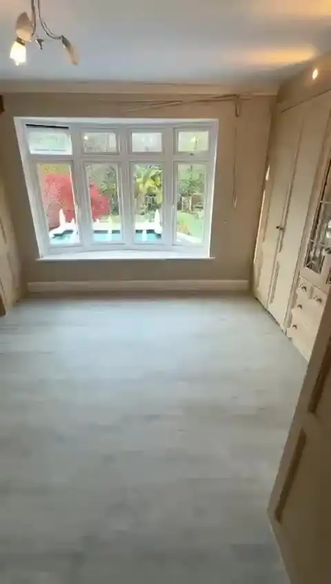 Reception room with large slate-effect porcelain floor tiles and fireplace